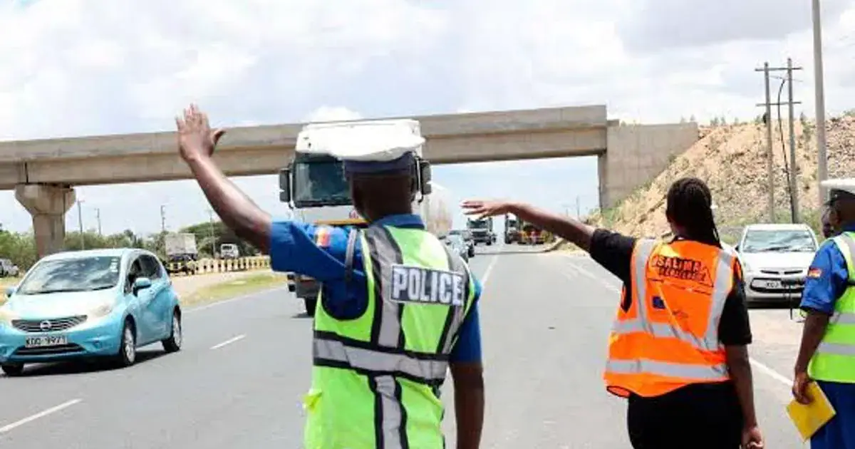 Traffic police officers wave down traffic at a road block on Thika Road (Image: Files)