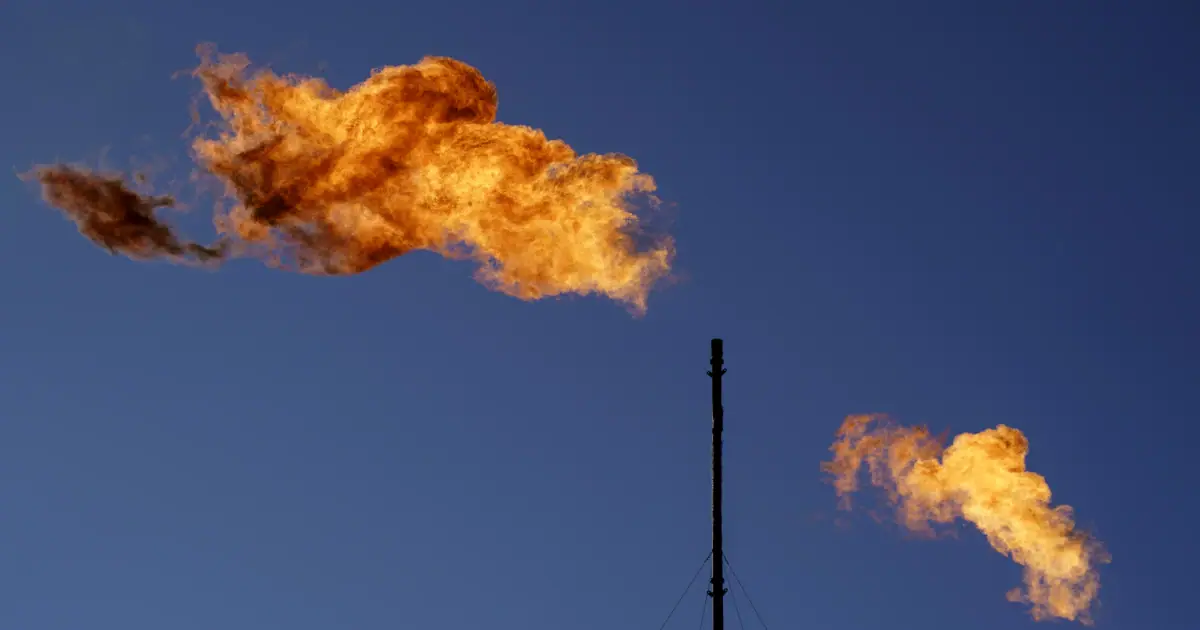 Flares burn off methane and other hydrocarbons at an oil and gas facility in Lenorah, Texas, Oct. 15, 2021.