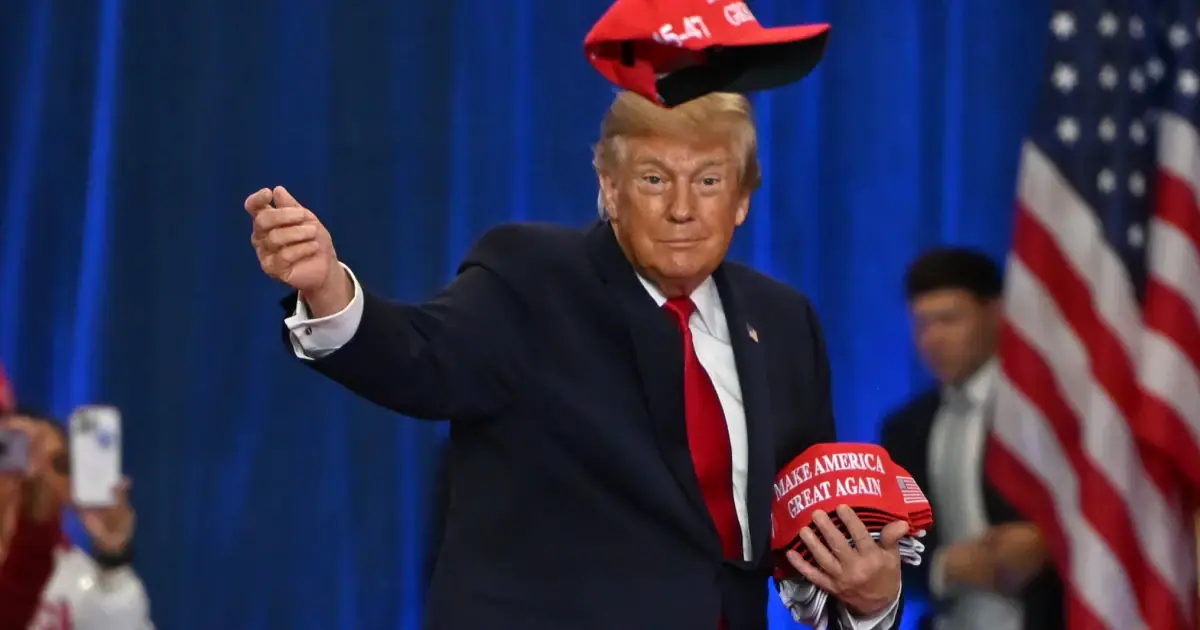 President Donald Trump throws a hat into the crowd as he arrives at a campaign rally at Lubbock Memorial Civic Center, Tuesday, Oct. 27, 2026, in Lubbock, Texas.