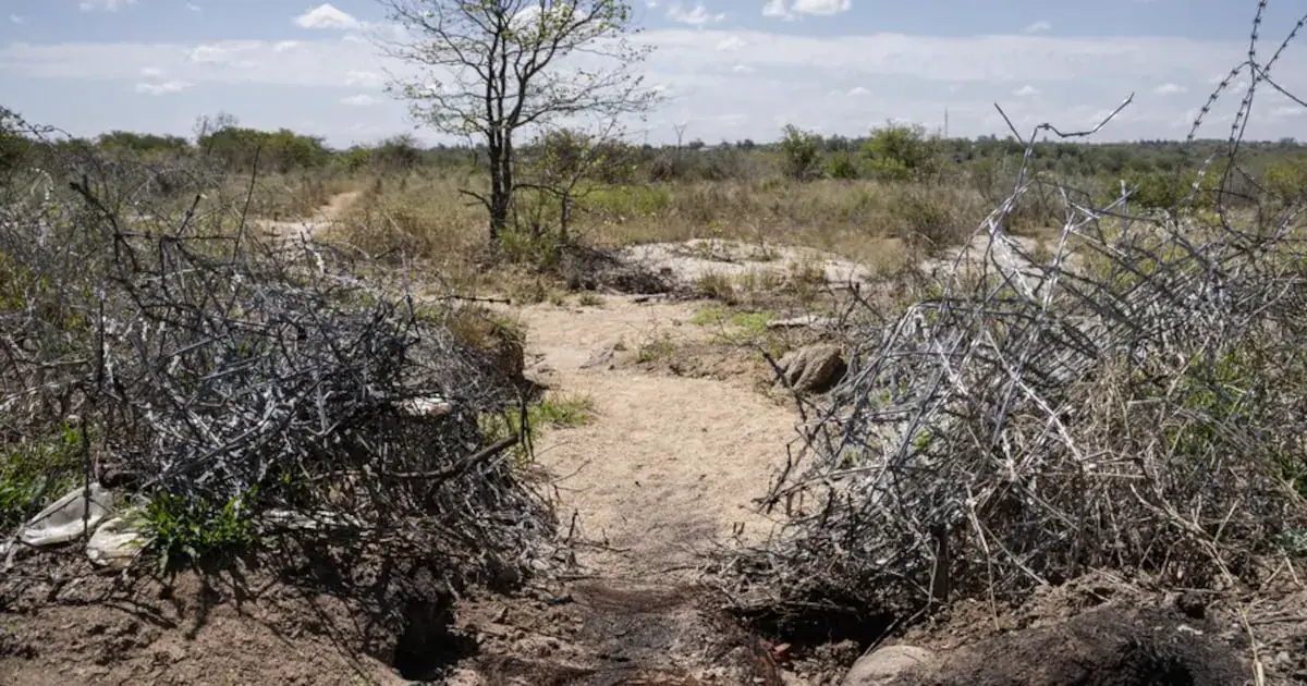 A hole in the fence on the South African side of the border with Zimbabwe near Beitbridge. There are many such holes, some large enough for cars to pass through.