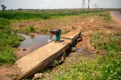Unsafe: Anna Kabini collects water in the murky Bronkhorstspruit River in Zithobeni. Photo Delwyn Verasamy