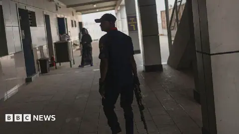 Armed member of the Nigeria Security and Civil Defence Corps (NSCDC) patrolling a train station