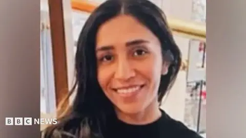 A head and shoulders image of Nusrat Osman wearing a black top.