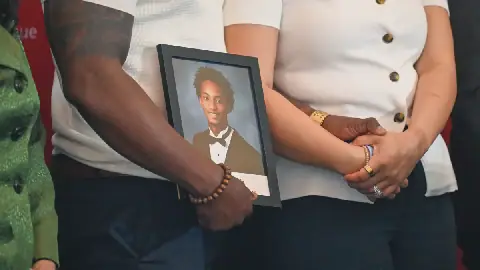 Christine Wonsley and Elmore Wonsley, mother and stepfather of Nolan Wells, stand on a stage with a photo of their son as they appear at the National Urban League's annual conference to share updates on his death on Thursday, July 30, 2026, in Nashville, Tenn.