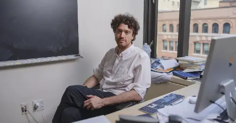 Tristan Buckmaster is a mathematician at New York University. He poses for a portrait in his office in Manhattan on September 11, 2026. Buckmaster and his collaborator Levent Alpöge have been working on the Navier-Stokes equations. They are clashing with OpenAI, which claims to have cracked the equations.