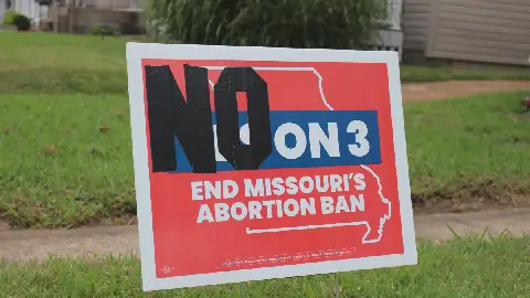 In Missouri, a "yes" vote on Amendment 3 in 2024 supported adding abortion protections to the state constitution. But in 2026, a "no" vote on Amendment 3 would keep those protections. Kelly McCoomb altered her sign from 2024 with duct tape and placed it back in her yard in Maplewood, Missouri.