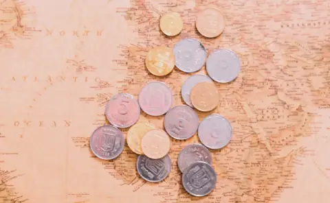 overhead-view-coins-open-jar-world-map