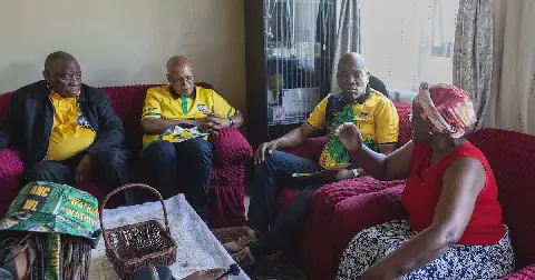 ANC president Cyril Ramaphosa, accompanied by ANC KwaZulu-Natal provincial convenor Mike Mabuyakhulu and eThekwini regional convenor Thabani Nyawose, listens as Makhosazana Mbikwana shares her story during a door-to-door campaign in eThekwini. Picture: