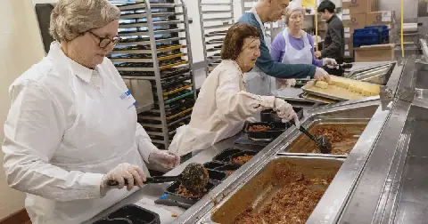 Volunteers prepare food at Community Servings, a Boston nonprofit that produces medically-tailored meals.