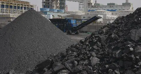 Piles of coal sit near a chemical plant in Datong, China, March 14, 2026. (AP Photo/Ng Han Guan, File)