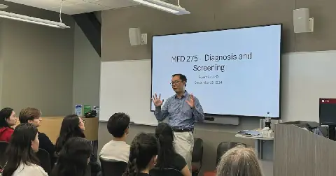 Dr. Bryant Lin teaches a lung cancer class in fall 2024. He says he was very nervous to teach the first class and share his story.