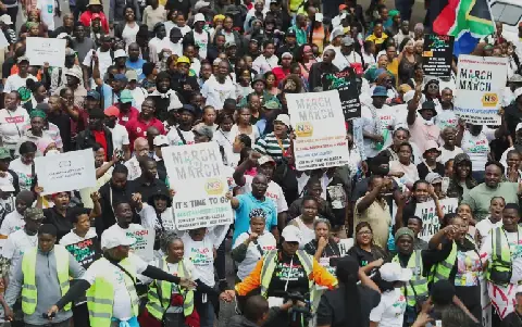 Protesters hold placards during an anti-immigration march in Durban, South Africa, calling for tighter border controls and the deportation of undocumented migrants [File: Thuli Dlamini/Reuters]