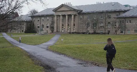 People walk on the campus of Cornell University in Ithaca, N.Y., in 2024.