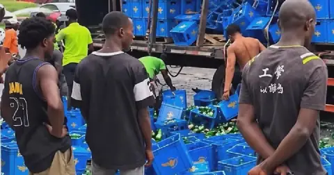 Nigerians ignore broken bottles, rush to drink spilled beer after van crashes in Lagos