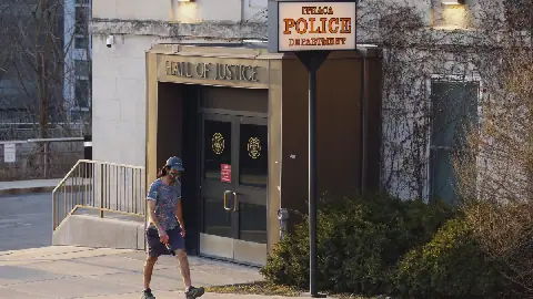 A person walks by the Ithaca Police Department headquarters on March 22, 2021, in Ithaca, N.Y.