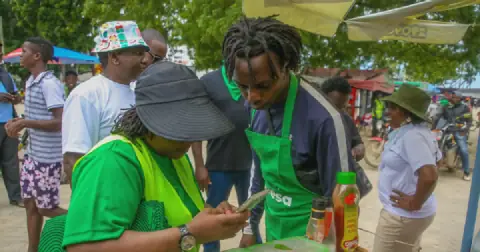 A Safaricom subscriber using her phone
