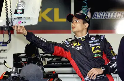 Alex Yoong of Malaysia checks his computer monitor in the Minardi garage during the lead-up to the Australian Formula One Grand Prix in Melbourne on February28 2002.
