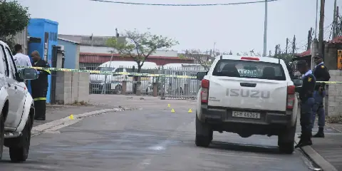 Police officials busy gathering evidence at the scene where a taxi owner from Zwelihle was gunned down.