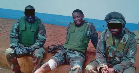 A wounded Lt-Col Solly Lechoenyo, centre, with two fellow Recce operators, appears unfazed after his deadly firefight in the Battle of Bangui. Picture: Michael Schmidt’s collection