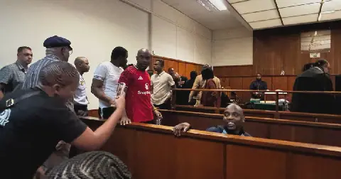 The seven accused leave the dock after one of several adjournments on day one of the AKA murder trial.