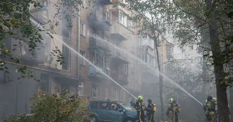 Firefighters work at the site of an apartment building damaged during a Russian drone strike, in Kyiv, Ukraine, on October 7 2026. Picture: Reuters/Gleb Garanich