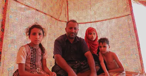 A man and his children sit in their tent in a makeshift camp for people displaced by clashes between Iran-aligned Houthi fighters and Saudi-backed Yemeni government forces, near Aden, Yemen, on October 7 2026. Picture: Reuters
