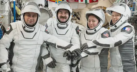 NASA's Crew-12 members gather for a portrait in the pressure suits they wore while departing the International Space Station inside the SpaceX Dragon spacecraft. From left, Roscosmos cosmonaut Andrey Fedyaev, NASA astronauts Jack Hathaway and Jessica Meir, and European Space Agency astronaut Sophie Adenot.