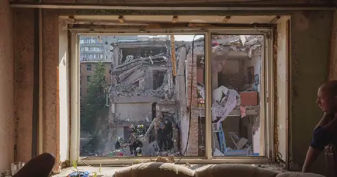 Locals and rescuers clear the rubble of a residential building destroyed in a Russian missile strike on Pryluky, Ukraine, Wednesday, Oct. 7, 2026.