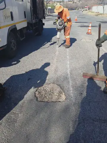 Service delivery: A broken road becomes a taxi owner's repair bill and lost earnings . . . blocked drain becomes a health hazard. Photos: JRA