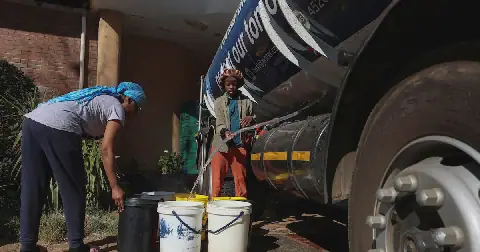 People collect water from a truck as dry taps have become a daily frustration for residents of Hillbrow, Johannesburg, South Africa, August 4, 2026. Picture: REUTERS/Oupa Nkosi