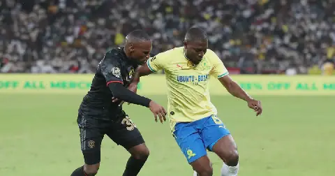 Aubrey Modiba of Mamelodi Sundowns challenged by Kamogelo Sebelebele of Orlando Pirates during the 2026 MTN8 final at Moses Mabhida Stadium in Durban on 10 October 2026.