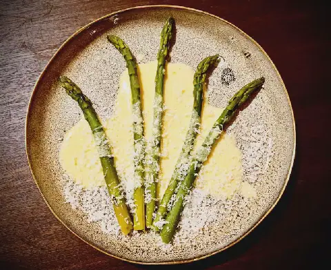 Asparagus spears with rosemary-infused Parmesan butter cream