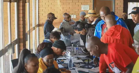 Community members sorting paperwork to receive their title deeds at Palm Ridge Community Hall. File picture: Mukovhe Mulidzwi