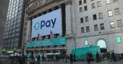 A giant OPay banner hangs across the front of the New York Stock Exchange, above US flags and an OPay-branded truck parked on the street