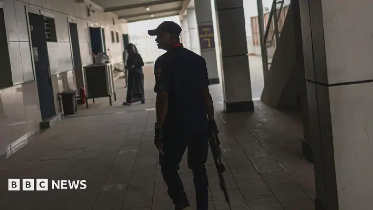 Armed member of the Nigeria Security and Civil Defence Corps (NSCDC) patrolling a train station